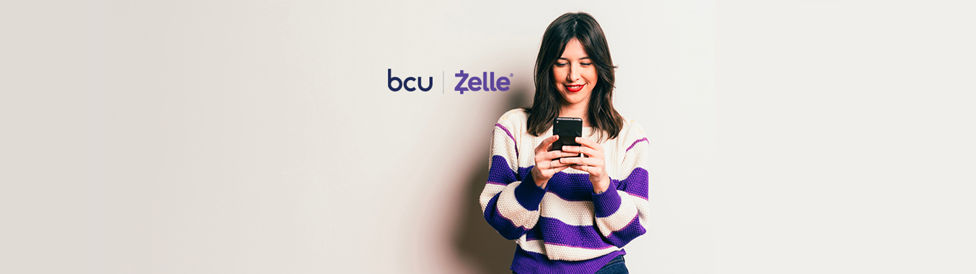 Woman looking at phone and smiling