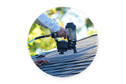 Person nailing on roof